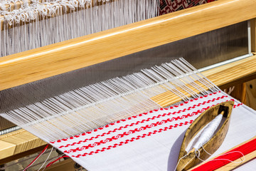 horizontal loom with linen, weaving in Belarus