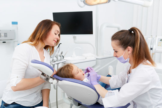 Dentists making treatment for little girl