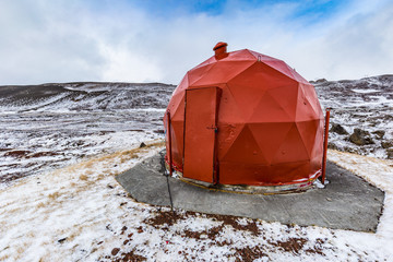 Red geodesic shed for technical equipment near the Krafla geothermal power plant at Lake Myvatn,...