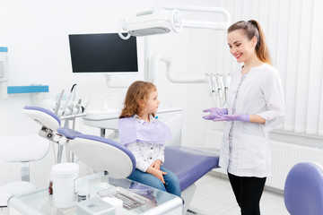 Dentist and small girl in cabinet