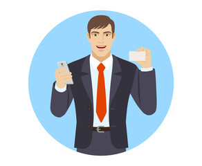 Businessman with mobile phone showing the business card