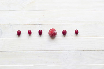 Naklejka na ściany i meble Motivation for success, priority of health, various berries on a white wooden background
