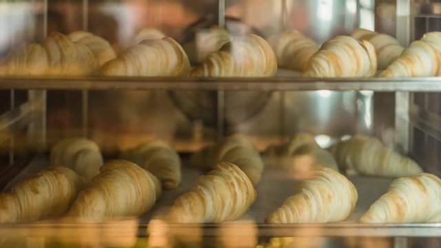 Classic French croissant are baking in the oven. Time lapse shot. 4k. Breakfast time. Background.