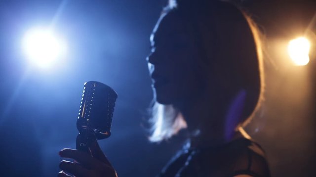 Silhouette of woman with retro style microphone