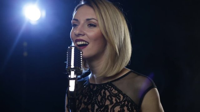 Pretty young woman jazz singer with mic