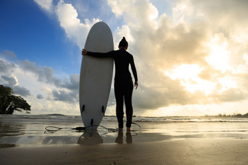 Young woman surfer with surfboard ready to surf