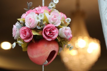 Fabric Flowers hanging at window  and electric lighting background decorate at home 
