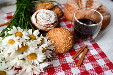 Coffee Cup, cracker, cookie, biscuit, chamomile flowers on a wooden table.