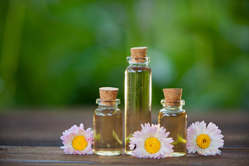 Essence of flowers on table in beautiful glass jar © solstizia