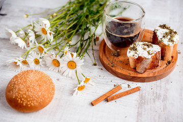 Coffee Cup, cracker, cookie, biscuit, chamomile flowers on a wooden table.