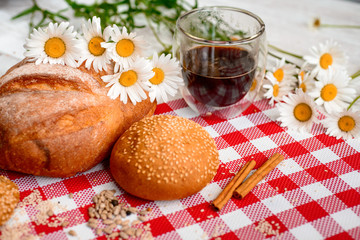 Coffee Cup, cracker, cookie, biscuit, chamomile flowers on a wooden table.