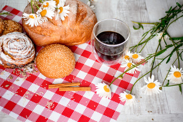 Coffee Cup, cracker, cookie, biscuit, chamomile flowers on a wooden table.