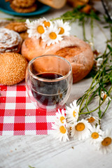 Coffee Cup, cracker, cookie, biscuit, chamomile flowers on a wooden table.