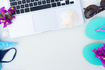 Summer beach fun mock up -laptop keyboard with blue swimming suit, sandals, sunglasses