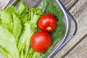 Vegetables on old wooden table - Tomatoes, onions, dill, lettuce