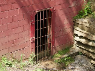 A secret backdoor locked with grills in the basement floor of a building
