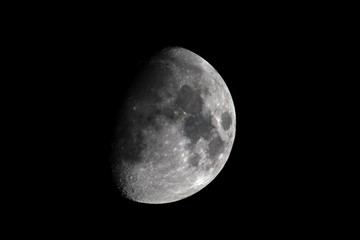 Right side view of a quarter moon with a black background