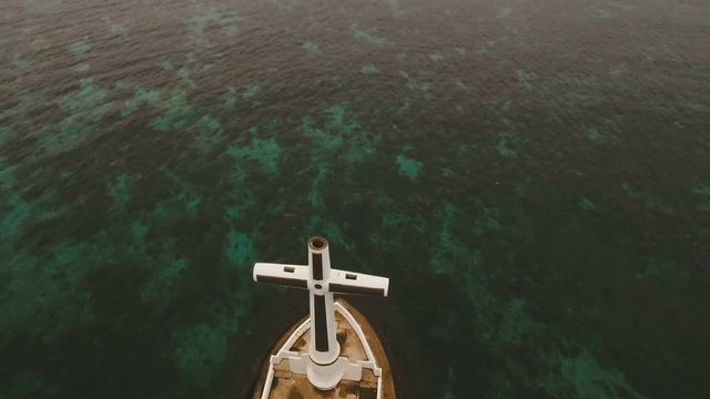 Aerial view Sunken Cemetery cross in Camiguin Island, Philippines. Large crucafix marking the underwater sunken cemetary of the coast of camiguin island near mindanao in the Philippines. Catholic