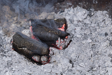 Smoldering sunflower shell biomass briquettes