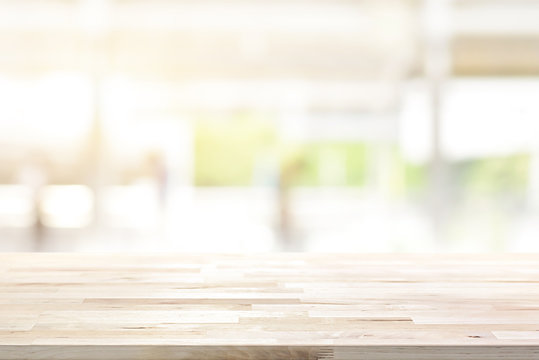 Wood table top on blur kitchen window background