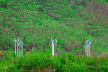 Group of wind turbines with mountain in background
