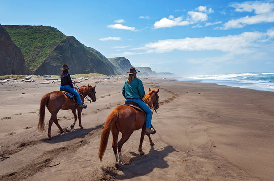 Horseback couple riding on Northern California Beach
