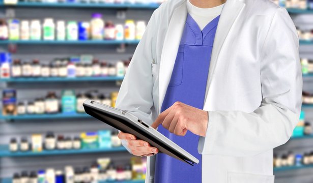 Pharmaceutical staff at drugstore with medicine in background