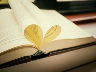 Open book with pages shaped like heart
