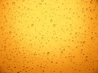 Rain water drop on yellow metal.