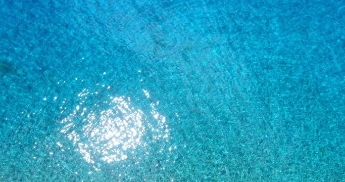 Ocean Aerial view turquoise blue sea water. High angle view of clear beautiful lagoon water in South Pacific Ocean in French Polynesia, Tahiti.