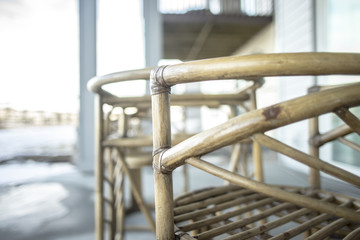 Fototapeta na wymiar Cane Chair outside on wooden deck in winter 