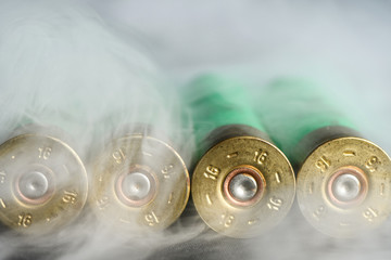Used, empty cartridges for shotguns in the entire frame in smoke