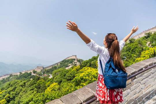 Freedom travel lifestyle woman student. Happy tourist backpacker at Great Wall of china having fun at famous Badaling ruins during travel holidays at Chinese destination. Asia vacation.