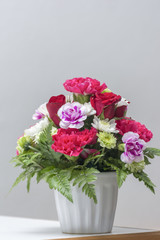 Bouquet Flowers in Vase on Table Gray background.