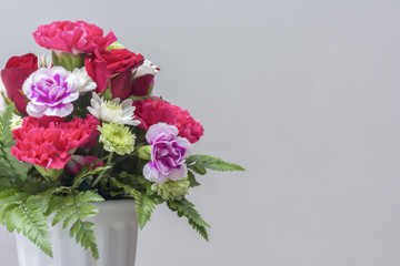 Bouquet Flowers in Vase on Table Gray background.