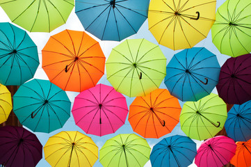 Fototapeta na wymiar Bright and vivid umbrellas in the sky for background