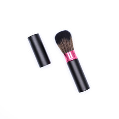 Closeup of a makeup brush with lid isolated on white background.