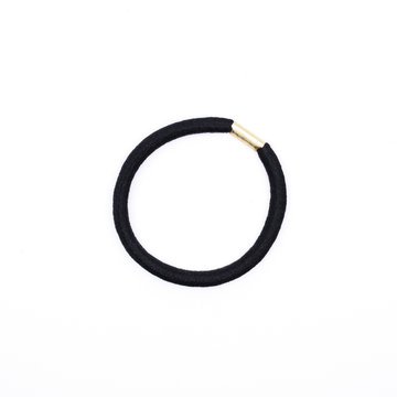 Closeup of a simple black hair band isolated on white background.
