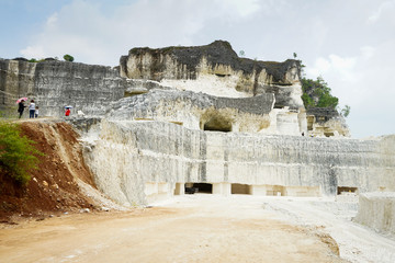 The exploitation of limestone hills forming a unique architectural in Jeddih or Jaddih Hill Madura Island, Indonesia