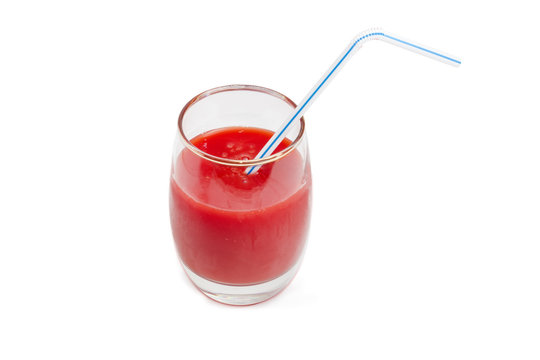 Glass of tomato juice with drinking straw