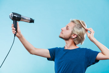 Trendy man with hair dryer © anetlanda