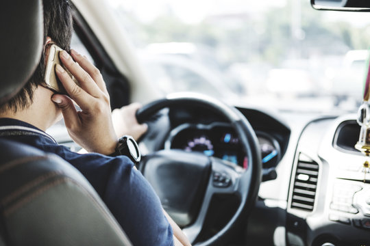 a man using telephone while driving car