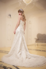 Fototapeta na wymiar portrait of a girl in an elegant wedding dress in a bright room