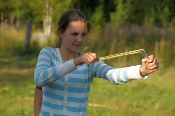 Girl with a slingshot in her hands