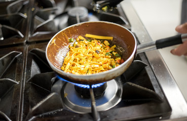 Cooking tagliatelle pasta on burners