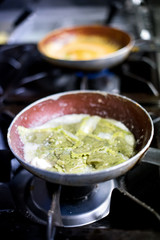Cooked ravioli on burners