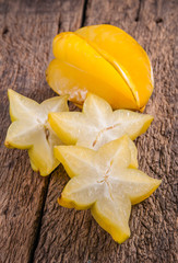yellow star fruit or star apple on wood background