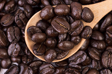 Coffee beans on wooden spoon