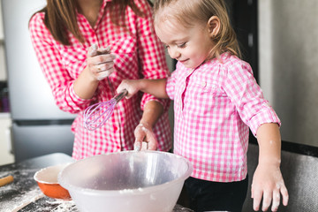 Mom and daughter together in the kitchen