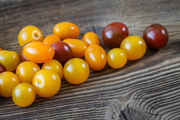 Cherry tomatoes on rustic wooden background
